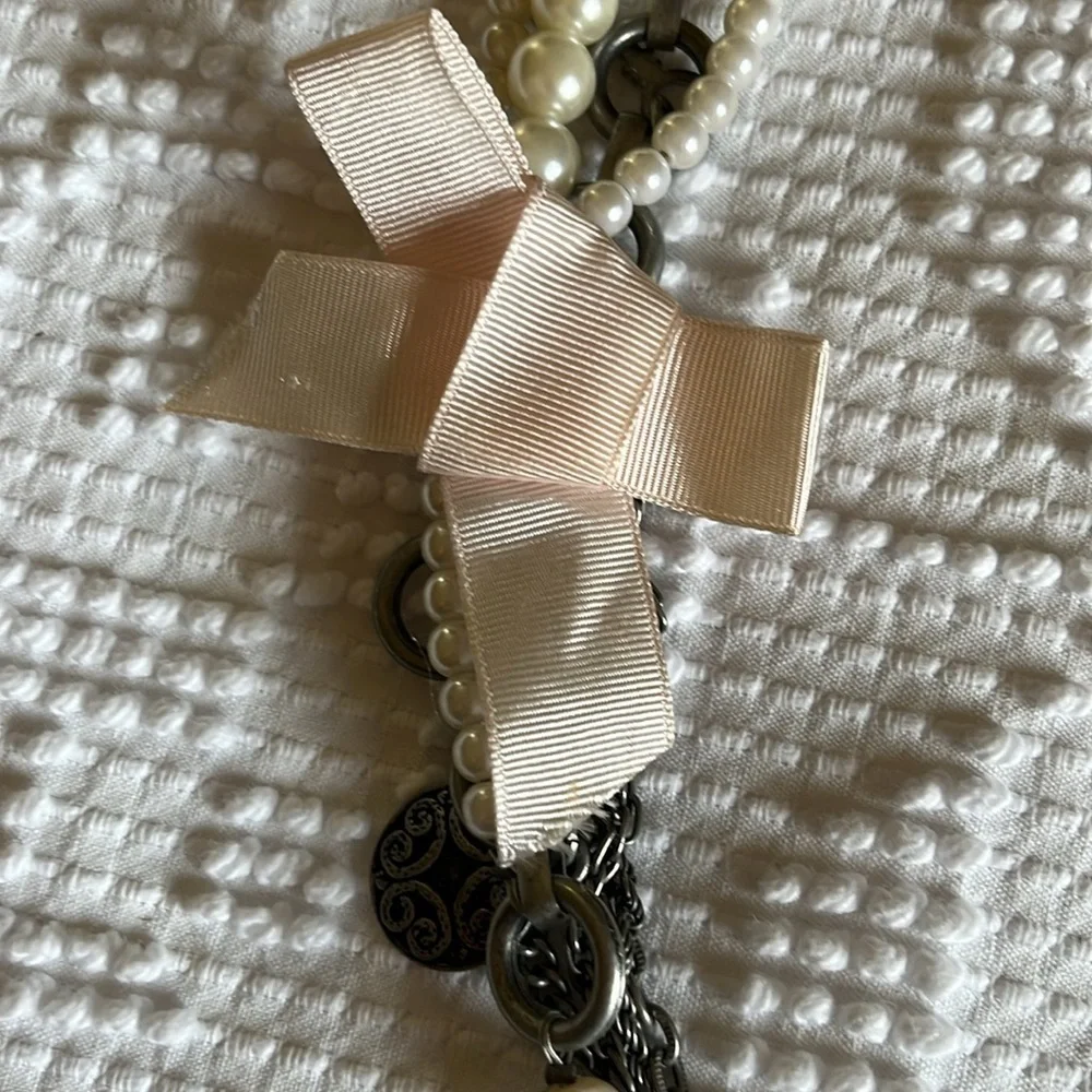 Women’s double chain belt. One of metal objects and the second chain of pearls.